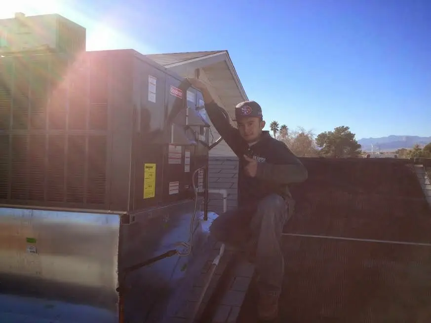 HVAC technician performing HVAC Inspection on a rooftop unit in Blooming Grove